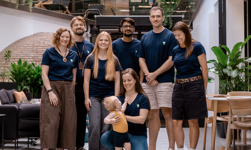 digitalRG team standing together in the office atrium, wearing navy t-shirts